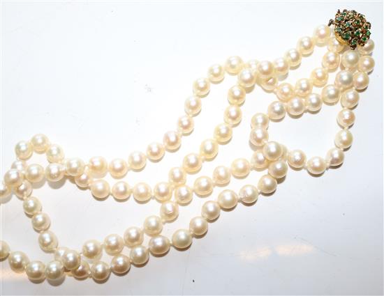 A two strand cultured pearl necklace, with emerald set gold clasp